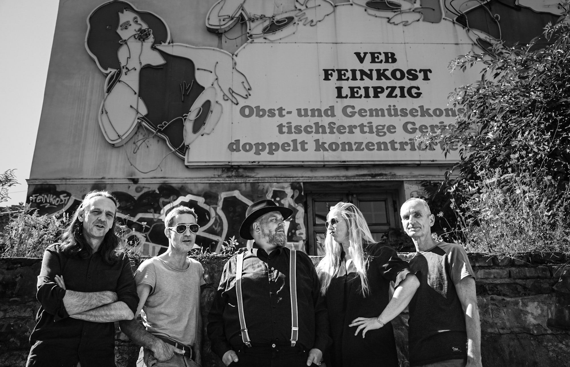 Die Band vor dem alten Schriftzug „VEB Feinkost Leipzig“